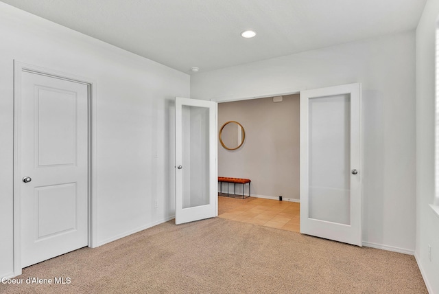 6314 Irish Dr, Rathdrum, ID 83858 - unfurnished bedroom with carpet, french doors, baseboards, recessed lighting, and tile patterned floors