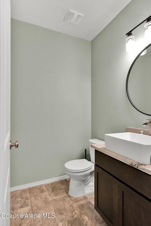 6314 Irish Dr, Rathdrum, ID 83858 - bathroom featuring vanity, toilet, and baseboards