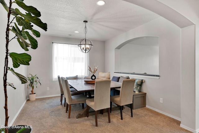 6314 Irish Dr, Rathdrum, ID 83858 - dining space featuring carpet floors, a chandelier, a textured ceiling, baseboards, and recessed lighting