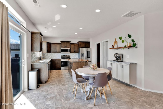 6314 Irish Dr, Rathdrum, ID 83858 - dining room with recessed lighting, baseboards, and light stone finish floors