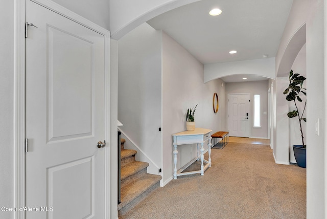6314 Irish Dr, Rathdrum, ID 83858 - foyer entrance featuring light carpet, arched walkways, baseboards, recessed lighting, and stairway