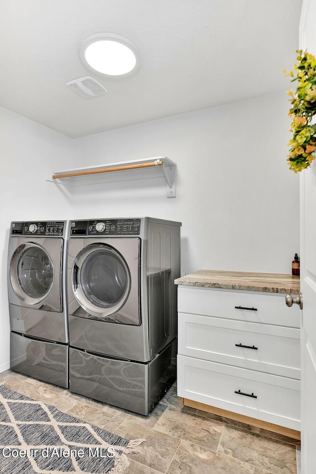 6314 Irish Dr, Rathdrum, ID 83858 - washroom featuring washing machine and dryer and light stone finish flooring