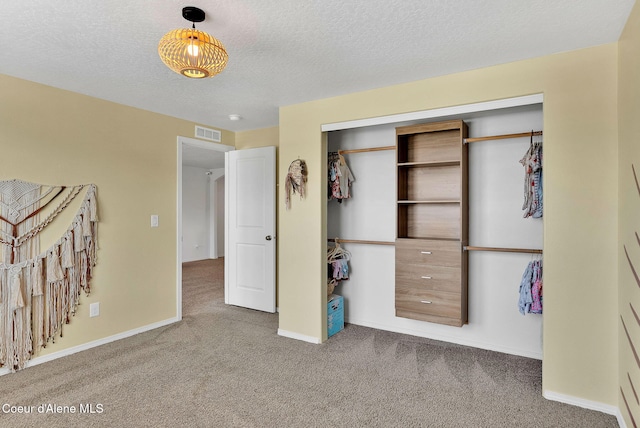6314 Irish Dr, Rathdrum, ID 83858 - bedroom featuring carpet floors, a closet, baseboards, and a textured ceiling