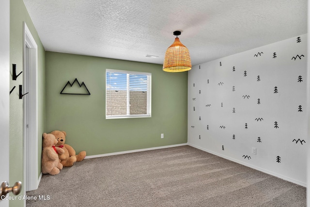 6314 Irish Dr, Rathdrum, ID 83858 - empty room featuring carpet, a textured ceiling, and baseboards