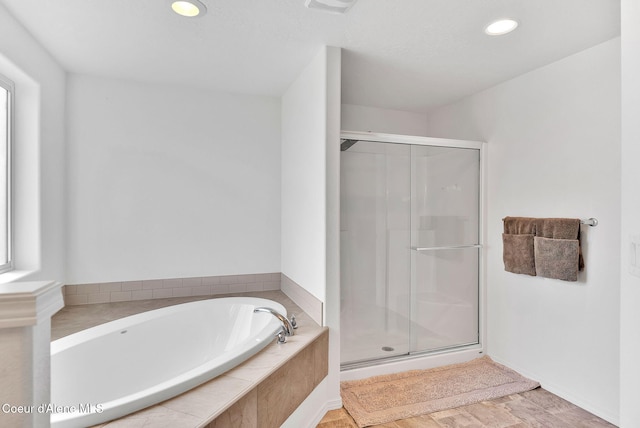6314 Irish Dr, Rathdrum, ID 83858 - full bath featuring a bath, a stall shower, recessed lighting, and wood finished floors