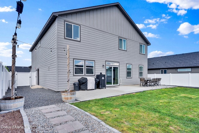6314 Irish Dr, Rathdrum, ID 83858 - rear view of property with a gate, a patio, and board and batten siding