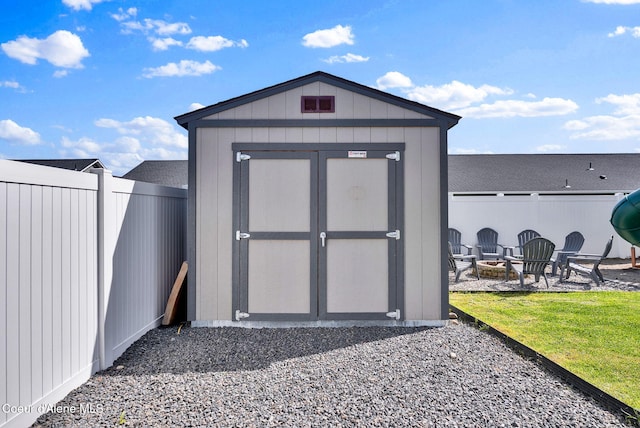 6314 Irish Dr, Rathdrum, ID 83858 - view of shed with a fire pit and a fenced backyard