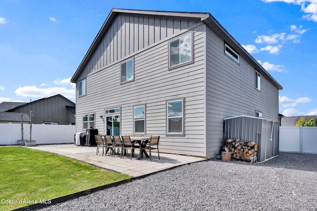 6314 Irish Dr, Rathdrum, ID 83858 - back of house with board and batten siding and a patio area