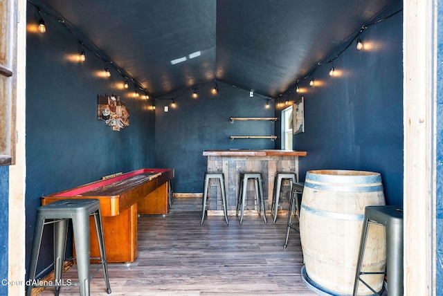 6314 Irish Dr, Rathdrum, ID 83858 - indoor dry bar featuring rail lighting, lofted ceiling, and wood finished floors