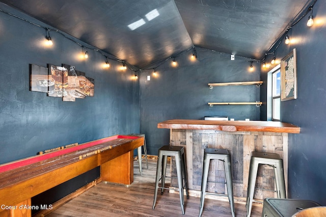 6314 Irish Dr, Rathdrum, ID 83858 - indoor wet bar featuring wood finished floors, rail lighting, and vaulted ceiling