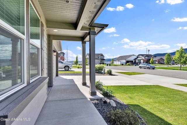 6314 Irish Dr, Rathdrum, ID 83858 - covered porch featuring a residential view and a lawn
