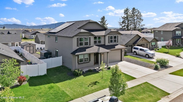6314 Irish Dr, Rathdrum, ID 83858 - view of front of house featuring a residential view, concrete driveway, a shingled roof, a garage, and a mountain view
