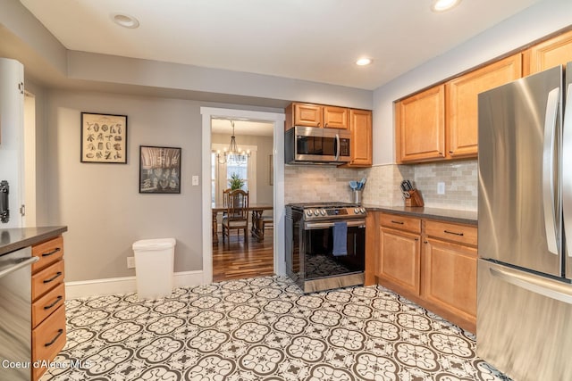 kitchen featuring stainless steel appliances, a chandelier, dark countertops, backsplash, and recessed lighting