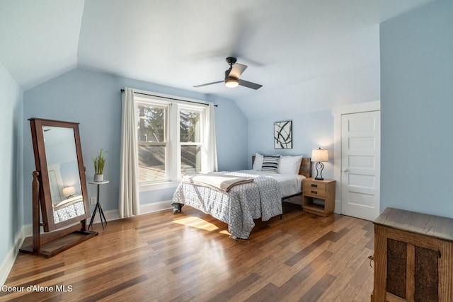 bedroom with lofted ceiling, wood finished floors, a ceiling fan, and baseboards
