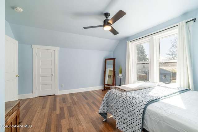 bedroom with lofted ceiling, wood finished floors, baseboards, and ceiling fan