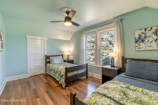 bedroom with vaulted ceiling, baseboards, dark wood-type flooring, and ceiling fan