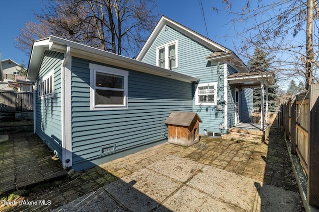 rear view of house featuring a patio area and a fenced backyard