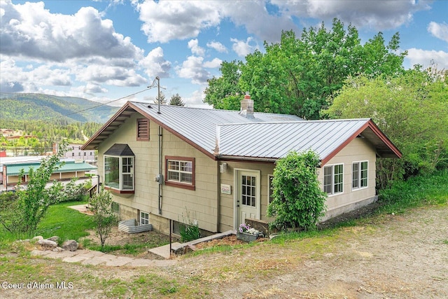 342 Summit Blvd, Priest River, ID 83856 - rear view of property featuring metal roof, a chimney, and a mountain view