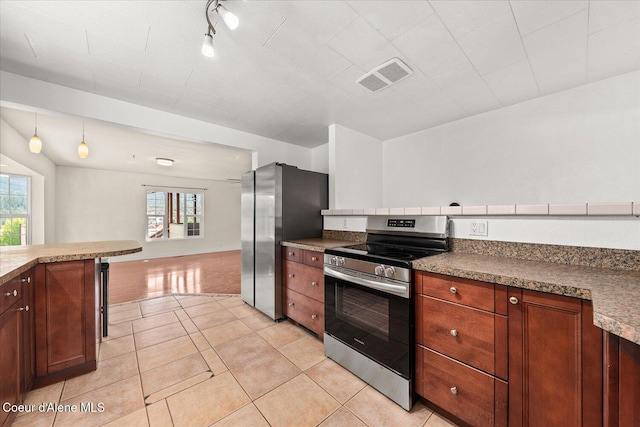 342 Summit Blvd, Priest River, ID 83856 - kitchen featuring stainless steel appliances, light tile patterned flooring, rail lighting, and open floor plan