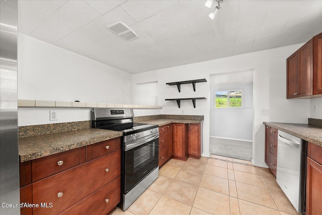 342 Summit Blvd, Priest River, ID 83856 - kitchen with stainless steel appliances, dark countertops, light tile patterned floors, and baseboards
