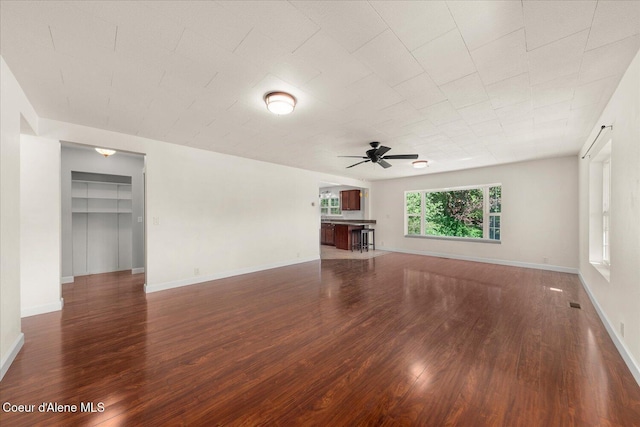 342 Summit Blvd, Priest River, ID 83856 - unfurnished living room featuring ceiling fan, wood finished floors, and baseboards
