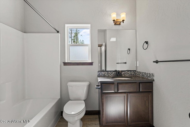 2060 E Plaza Ct, Post Falls, ID 83854 - bathroom with toilet, vanity, wood finished floors, and washtub / shower combination