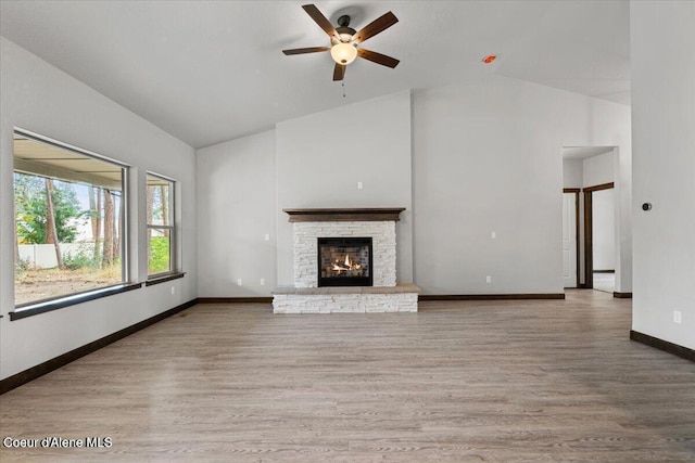 2060 E Plaza Ct, Post Falls, ID 83854 - unfurnished living room featuring high vaulted ceiling, ceiling fan, wood finished floors, baseboards, and a fireplace