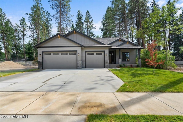 2060 E Plaza Ct, Post Falls, ID 83854 - craftsman house with a garage, board and batten siding, concrete driveway, a front yard, and stone siding