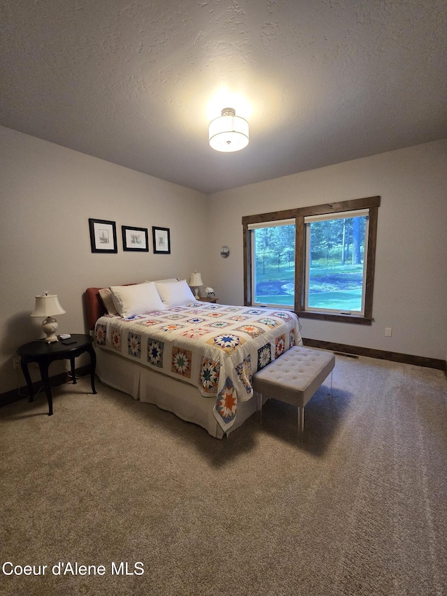 12552 N Walden Loop, Rathdrum, ID 83858 - carpeted bedroom featuring baseboards and a textured ceiling