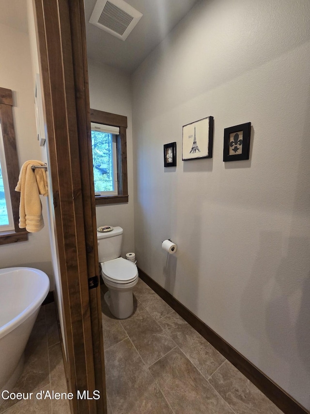 12552 N Walden Loop, Rathdrum, ID 83858 - bathroom with toilet, baseboards, and a soaking tub