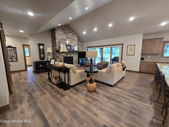 12552 N Walden Loop, Rathdrum, ID 83858 - living room featuring baseboards, a fireplace, dark wood finished floors, recessed lighting, and high vaulted ceiling