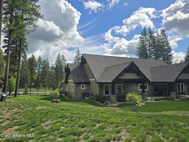 12552 N Walden Loop, Rathdrum, ID 83858 - rear view of house featuring a patio area, a shingled roof, a hot tub, and cooling unit
