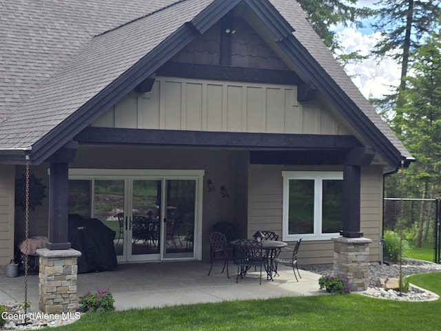 12552 N Walden Loop, Rathdrum, ID 83858 - rear view of property featuring board and batten siding, a patio area, roof with shingles, and french doors