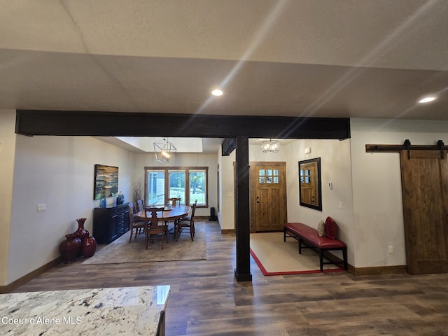 12552 N Walden Loop, Rathdrum, ID 83858 - dining space featuring a barn door, dark wood-style flooring, baseboards, and recessed lighting