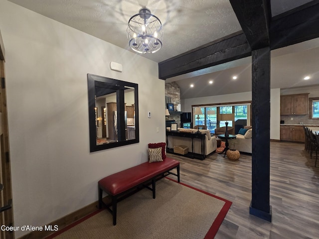 12552 N Walden Loop, Rathdrum, ID 83858 - living room featuring dark wood-style flooring, recessed lighting, a chandelier, baseboards, and lofted ceiling