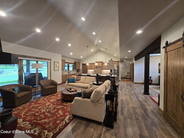 12552 N Walden Loop, Rathdrum, ID 83858 - living area featuring lofted ceiling, a barn door, dark wood finished floors, recessed lighting, and stairway