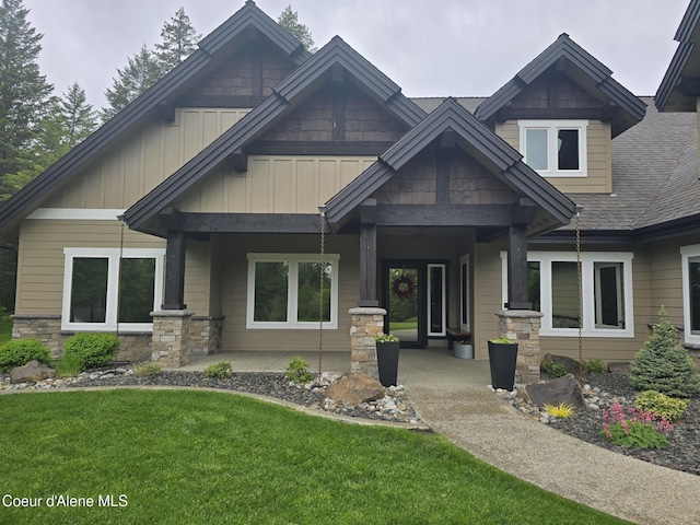12552 N Walden Loop, Rathdrum, ID 83858 - craftsman-style home with a front yard, board and batten siding, covered porch, and stone siding