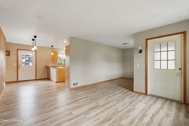 410 Humbird St, Kootenai, ID 83840 - unfurnished living room featuring light wood-style flooring and baseboards