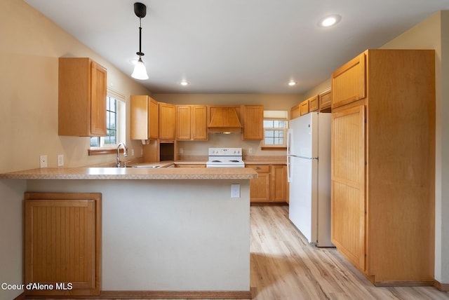 410 Humbird St, Kootenai, ID 83840 - kitchen featuring white appliances, premium range hood, a peninsula, light countertops, and a sink