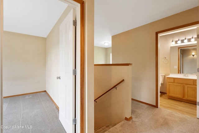 410 Humbird St, Kootenai, ID 83840 - corridor featuring an upstairs landing, light carpet, a sink, and baseboards