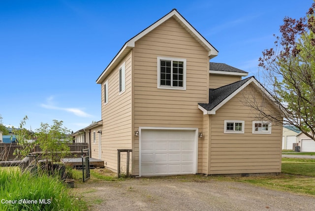 410 Humbird St, Kootenai, ID 83840 - view of side of home featuring dirt driveway, a garage, and roof with shingles