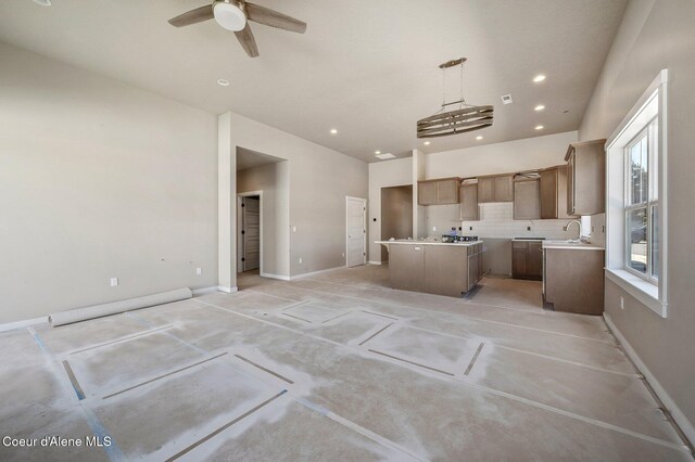 7414 N Breaux Dr, Coeur Dalene, ID 83815 - kitchen featuring a center island, ceiling fan, decorative backsplash, open floor plan, and recessed lighting