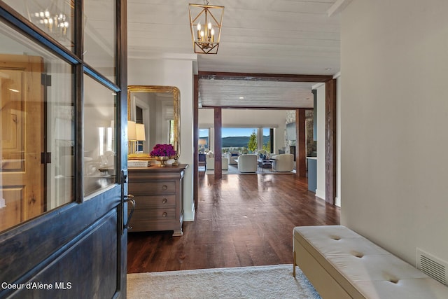 7783 S Buckrail Rd, Harrison, ID 83833 - hallway featuring a chandelier and dark wood-style floors