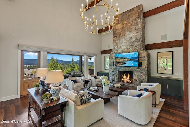 7783 S Buckrail Rd, Harrison, ID 83833 - living area with a high ceiling, a chandelier, wood finished floors, a stone fireplace, and baseboards
