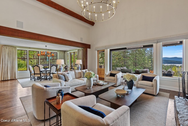 7783 S Buckrail Rd, Harrison, ID 83833 - living room with a chandelier, dark wood-style flooring, beamed ceiling, and a towering ceiling