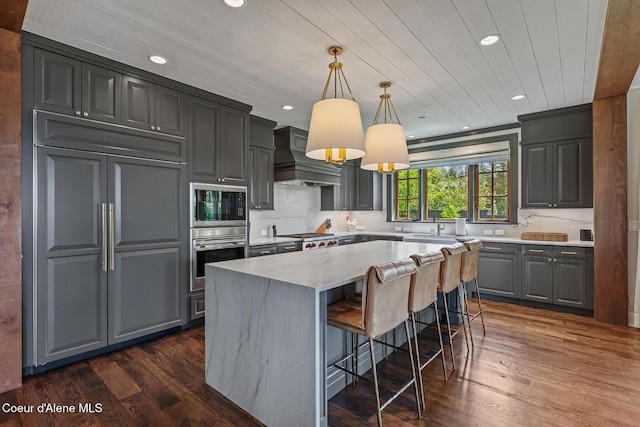 7783 S Buckrail Rd, Harrison, ID 83833 - kitchen with built in appliances, custom exhaust hood, dark wood-style flooring, recessed lighting, and gray cabinets