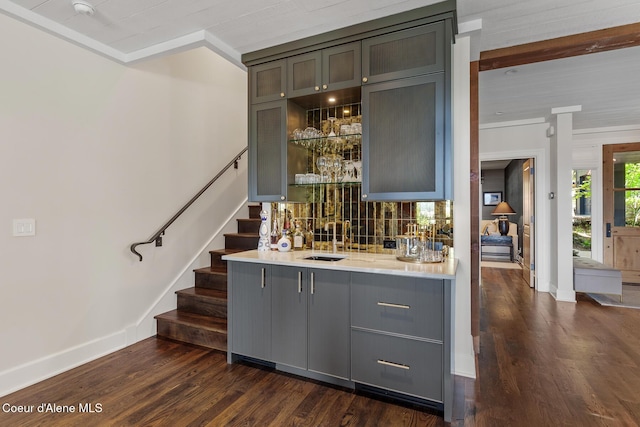 7783 S Buckrail Rd, Harrison, ID 83833 - indoor wet bar with baseboards, dark wood-style flooring, stairs, ornamental molding, and decorative backsplash