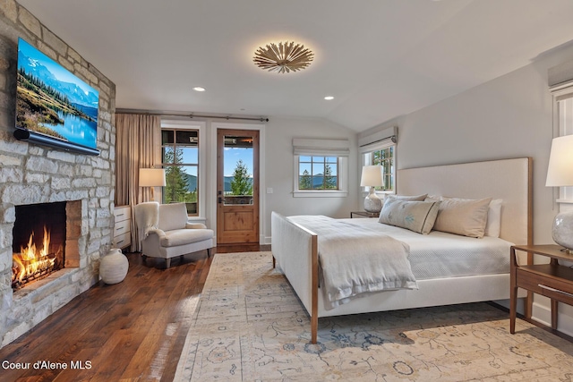 7783 S Buckrail Rd, Harrison, ID 83833 - bedroom with hardwood / wood-style floors, a stone fireplace, access to outside, recessed lighting, and vaulted ceiling