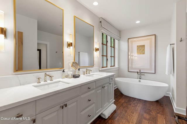 7783 S Buckrail Rd, Harrison, ID 83833 - bathroom featuring double vanity, a soaking tub, wood finished floors, and recessed lighting