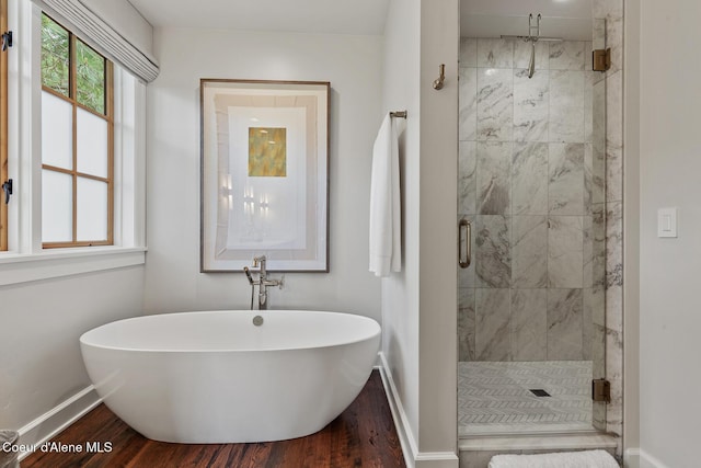 7783 S Buckrail Rd, Harrison, ID 83833 - full bath with baseboards, a freestanding tub, wood finished floors, and a stall shower